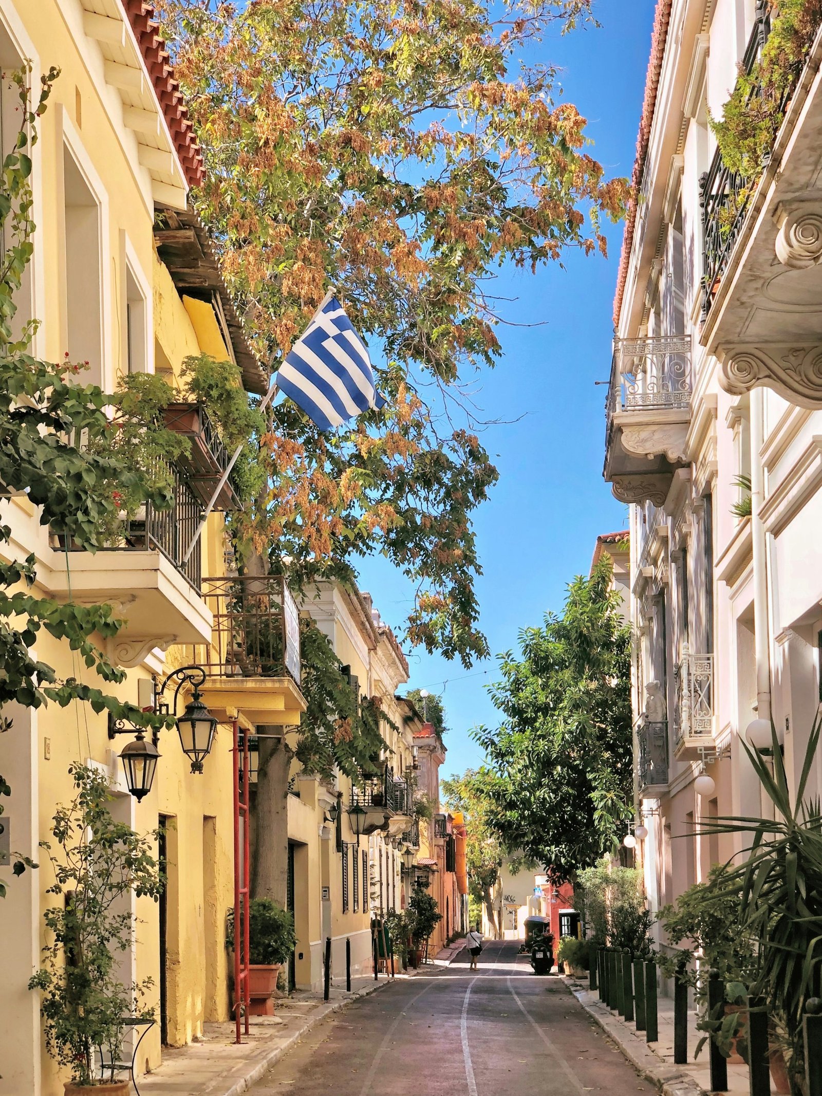 Plaka neighborhood street with Greek flag